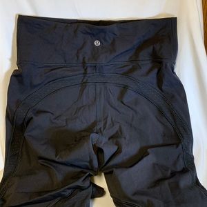 Lululemon 3/4 legging with polka dot mesh pattern fabric on the back of the leg.